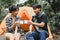 Young People Trekking Holding Water Cups for Drink in the Forest. Campsite Drinking Coffee