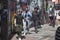 Young people walk along the sidewalk along Brick Lane Street