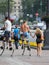 Young people walking on the street on a jumping stilts