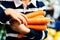 Young Person Carrying Armful of Fresh Organic Carrots Farmers Market Closeup Vegetables Food