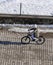 a young person moving on a bicycle on the street, a bicycle and a young person, using a bicycle on the road