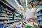 Young person with protective face mask buying groceries/supplies in the supermarket.Preparation for a pandemic quarantine