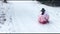Young person riding a sleigh down hill of a ski slope, winter sports and fun, adult and kid toys for the winter holidays