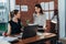 Young personal assistant discussing plans with boss in her office