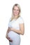 Young Petty Natual Beauty Pregnant Woman Shows a Belly That Begins to Grow Isolated on White Background. 20 Weeks of Pregnancy.