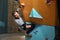 Young physically challenged boulderer hanging at colourful climbing wall