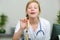 young physician holding wooden tongue stick