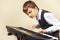 Young pianist in suit playing the electronic organ