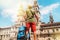 Young pilgrim backpacker man standing on the Obradeiro square plaza - the main square in Santiago de Compostela as a end of his