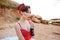 Young pin up woman drinking sweet drink from glass bottle