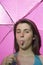 Young pink umbrella sticking out tongue