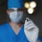 Young plastic surgeon is holding a scalpel. Doctor is preparing for surgery. Close-up.
