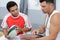 young player talking game strategy with coach in changing room