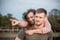 Young playful couple in love at the beach, the man carries the woman on his back