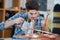 Young plumber using welding gas torch to solder copper pipes