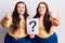 Young plus size twins holding question mark annoyed and frustrated shouting with anger, yelling crazy with anger and hand raised