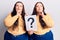 Young plus size twins holding question mark serious face thinking about question with hand on chin, thoughtful about confusing