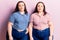 Young plus size twins wearing casual clothes looking sleepy and tired, exhausted for fatigue and hangover, lazy eyes in the