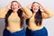 Young plus size twins wearing casual clothes smiling cheerful playing peek a boo with hands showing face