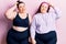 Young plus size twins wearing sportswear confuse and wonder about question