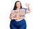 Young plus size woman holding united we stand banner with angry face, negative sign showing dislike with thumbs down, rejection