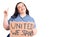 Young plus size woman holding united we stand banner surprised with an idea or question pointing finger with happy face, number