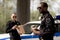 young police officers with coffee to go and paper bag with lunch