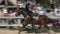 Young policeman doing tricks on galloping horse.