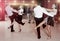 Young positive people dancing vigorous jive movements in dance studio