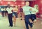 Young positive people dancing vigorous jive movements in dance studio