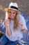 Young positive playful blonde woman eating strawberry on picnic