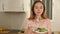 Young positive woman enjoying salad