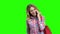 Young positive woman using phone on green screen.