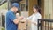 Young postal delivery courier man holding parcel boxes for sending to customer, Asian woman signing on paper for receive delivered