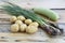 Young potatoes, scallions and zucchini on a wooden table.