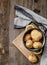 Young potatoes sitting on cutting board, topview