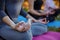 Young practitioners doing yoga exercises in park. Women meditate outdoor infront of beautiful autumn nature. Hands