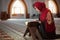 Young praying woman falling on knees in mosque