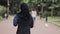 Young Preety Muslin Girl Wearing a Hijabt Running in the Park Back Side View Concept Healthy Lifestyle.