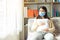 Young pregnant asian woman in medical mask stay alone at home for self quarantine. home quarantine, prevention covid 19,