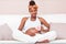 Young pregnant black woman touching her belly - African people