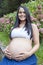 Young pregnant Brazilian woman touching her belly