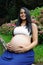 Young pregnant Brazilian woman touching her belly