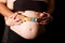 Young pregnant couple holding wood playing blocks