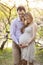 Young pregnant couple outdoors in spring