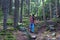 Young pregnant female hiking along on mountain path