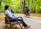 Young pregnant mother sitting on bench