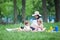 Young pregnant mother with two girls on a picnic playing