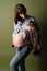 Young pregnant woman with  big belly holds cat in her arms