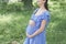 Young pregnant woman enjoy in spring day.